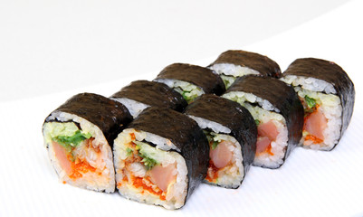 Roll with caviar of salmon. Sushi with caviar of flying fish. Japanese food on a beautiful dish.
