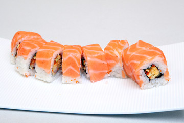 Roll Tokyo. Sushi with salmon, eel, tender cheese. Japanese food on a beautiful dish.