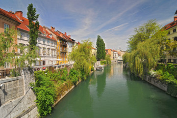 Fototapeta na wymiar Panorama of river Ljubljanica and colorful buildings in Ljubljanas old town center, Slovenia.