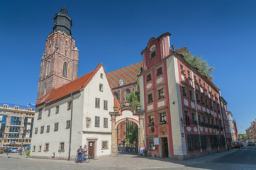 Obraz premium Jas and Malgosia (Johnny and Mary) miniature houses and St Elizabeth Church in Wroclaw, Silesia, Poland.