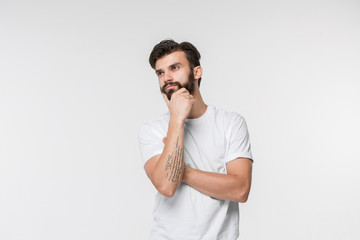 Remember all. Let me think. Doubt concept. Doubtful, thoughtful man remembering something. Young emotional man. Human emotions, facial expression concept. Studio. Isolated on white. Front