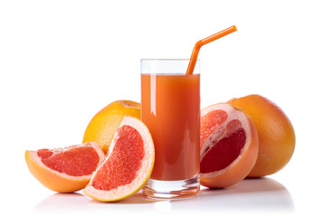 Glass of fresh grapefruit juice and cut fruits white background.