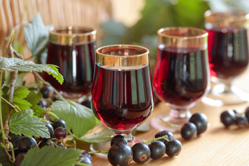 Homemade black currant liqueur and fresh berries.