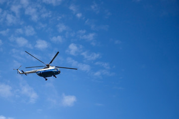 Russian helicopter flying in the sky. Air transport on the background of clouds. 