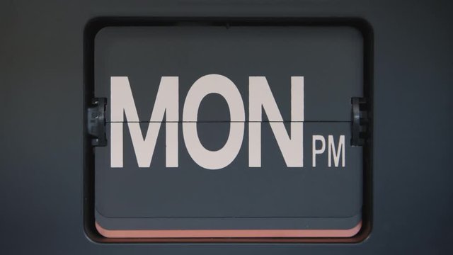 Retro flip calendar showing days of the week. Shot in 4K slow motion.