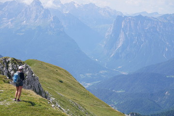 Great view of a hiker in the green valley in the alps