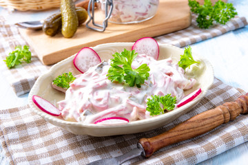delicious homemade meat salad with mayonnaise and cucumber