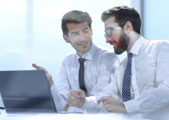 two business colleagues discuss the information sitting at the Desk