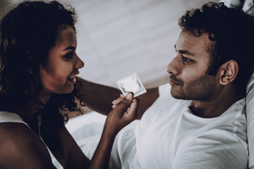 Young Couple Sex Concept. Girl Holds A Condom.