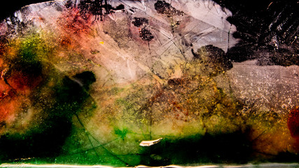 Ice plate melting. Green, red, orange, white. Multicolor. 