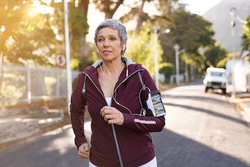 Senior woman jogging in the street