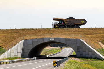 Coal truck driving across overpass