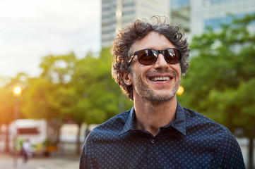 Happy man wearing sunglasses - Powered by Adobe