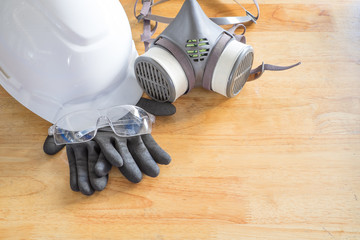 Standard personal protective equipment on wooden table. top view, concept safety 