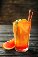 Fresh summer cocktail in glass on wooden table