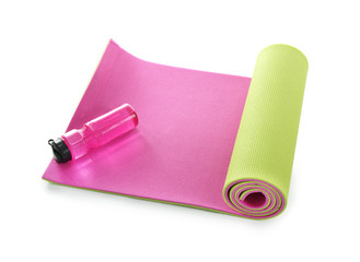 Yoga mat with bottle of water on white background