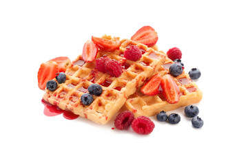 Delicious waffles with jam and berries on white background