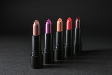 Colourful lipsticks on black background