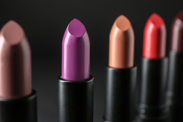 Obraz premium Colourful lipsticks on black background