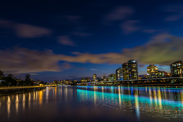 Fototapeta na wymiar City dividing river at night