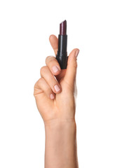 Woman holding dark color lipstick on white background