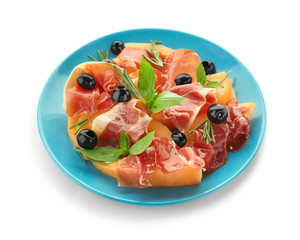 Plate with delicious melon, prosciutto and olives on white background