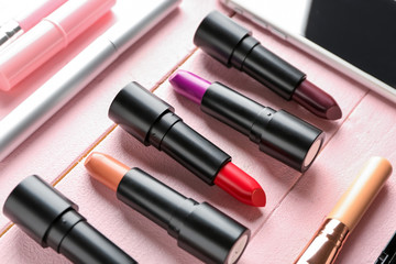 Obraz premium Different lipsticks on color table