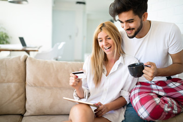 Happy couple surfing on tablet at home