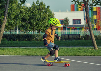 A little boy enjoys a yellow cruiser penny plastboard