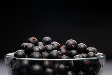 Photo of black currant in glass transparent cup