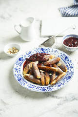 Fried potato dumplings with cherry sauce