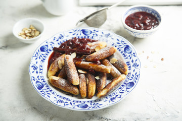 Fried potato dumplings with cherry sauce