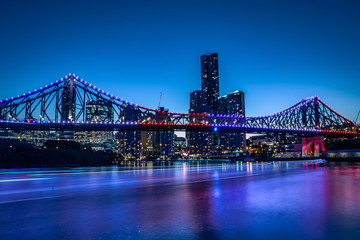 Fototapeta na wymiar Bright glowing bridge in cityscape