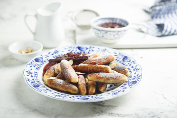 Fried potato dumplings with cherry sauce