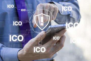 Businessman presses button shield virus security web icon on virtual network ico Initial Coin Offering.