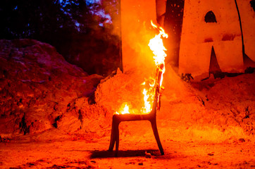Wooden chair is on fire. Incineration of furniture. Conceptual photo, burnout