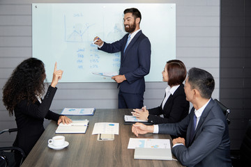 Group of diverse coworkers on business meeting having presentation with board