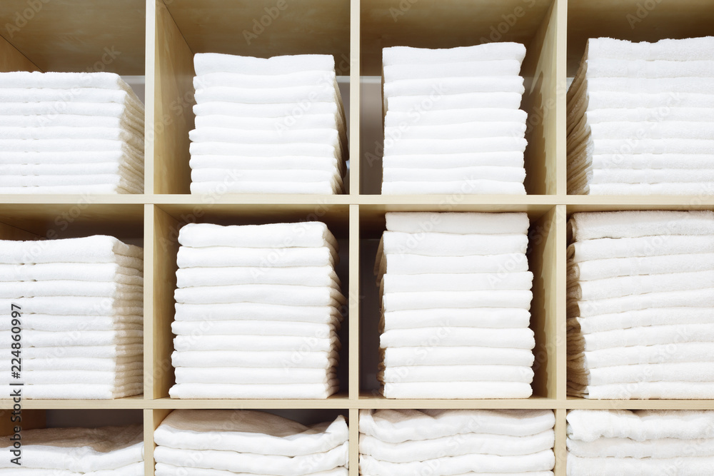 Aufkleber white towels folded and stacked on a shelf