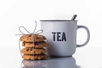 Breton gift biscuits and a cup of tea on a white background with steam.