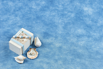 box with seashells on a blue background