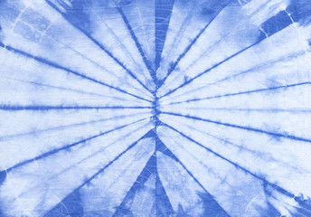 Abstract tie dyed fabric of indigo color on white cotton. Hand painted fabrics. Shibori dyeing