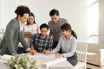 Vietnamese business team working on construction project together