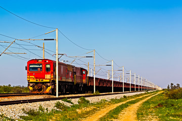 Red electric narrow gauge locomotive and train
