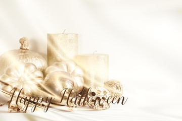 Light coloured Halloween image with gold pumpkins and gold candles, and quote 'Happy Halloween'. Great for social media and blog accounts.