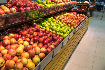 Fresh healthy fruits on shelves in supermarket