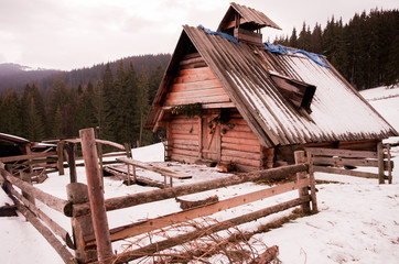 A wooden house in a clearing. Winter landscape with a house.