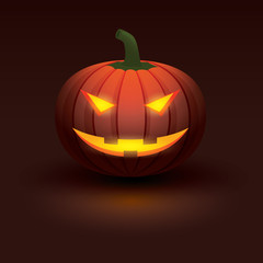 Halloween pumpkin with light glowing in smiling face on dark background.