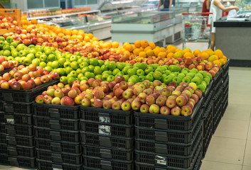 Fototapeta na wymiar Fresh healthy fruits on shelves in supermarket