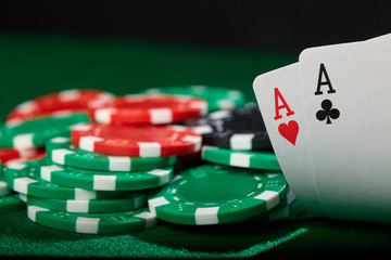 Poker player showing cards. A pair of aces. Winning hand.