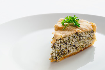 pie with brynza, cottage cheese, and herbs decorated with parsley